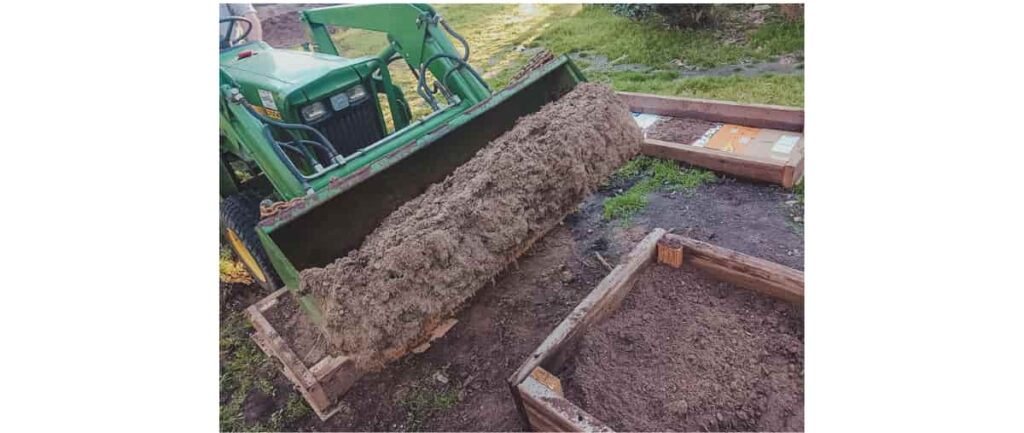 Planning a kitchen garden with wooden raised beds, filling the beds with planting mix.